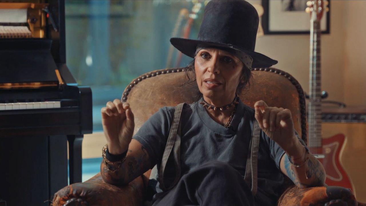 Linda Perry sitting in a chair and talking